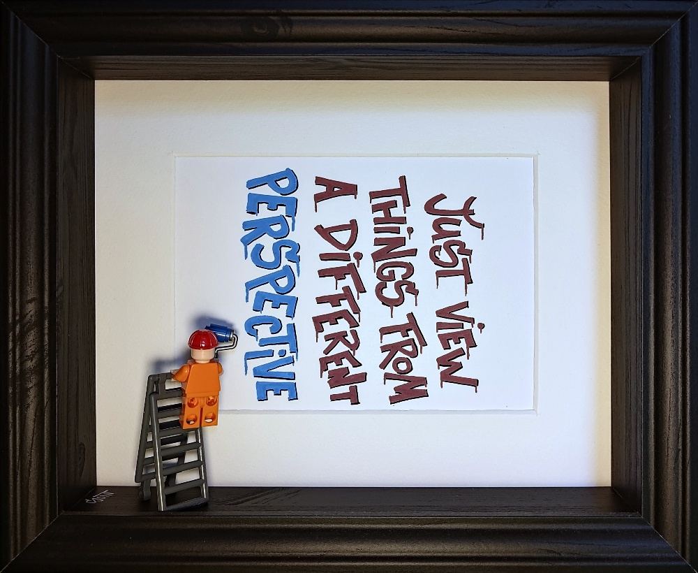 'Just view things from a different perspective' lettered sideways in plum and blue. A tiny painter on a ladder is rolling on the blue word Perspective.
